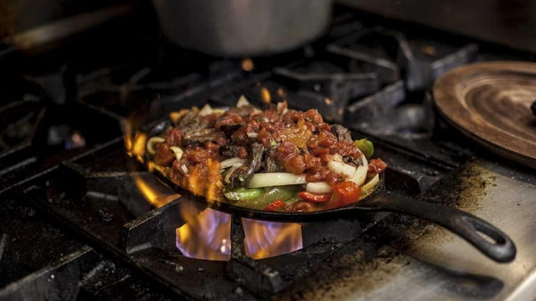 A beef fajita platter cooks on the stove at Sombrero's...
