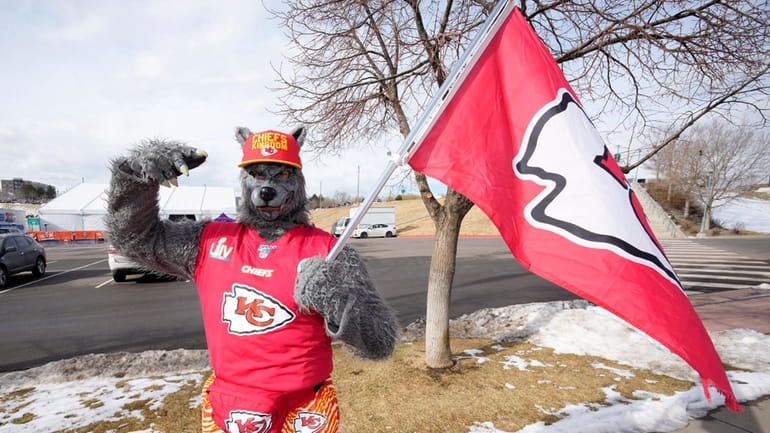 A Kansas City Chiefs fan, Chiefsaholic, poses for photos while...
