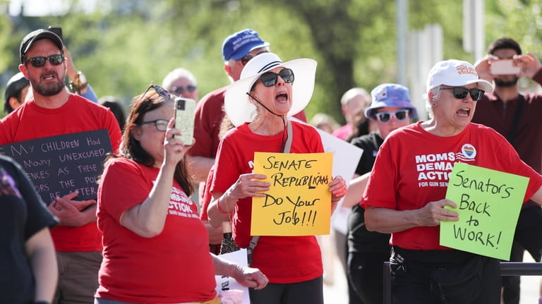 Attendees chant during a rally calling for an end to...