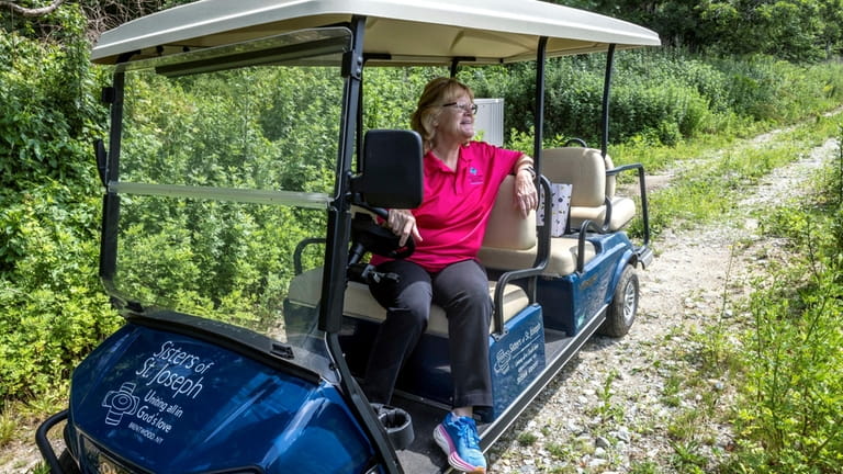 Sister Karen Burke pauses while driving around the campus.