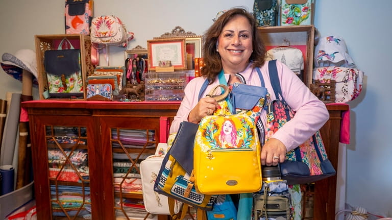 Maria Zdrojeski, 64, shows off some of her designs inside her...