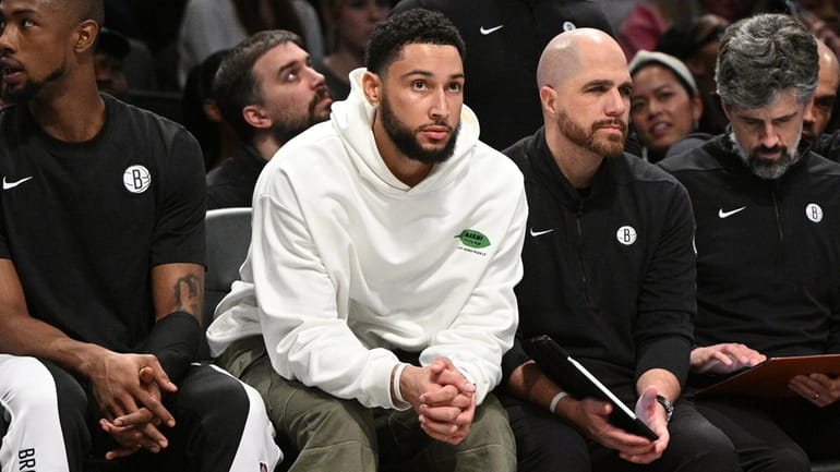 Nets guard Ben Simmons, second from left, looks on from...