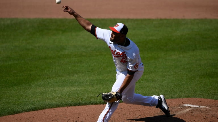 Baltimore Orioles starting pitcher Albert Suarez throws during the fourth...