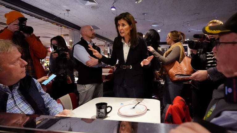 Republican presidential candidate former UN Ambassador Nikki Haley, center, chats...