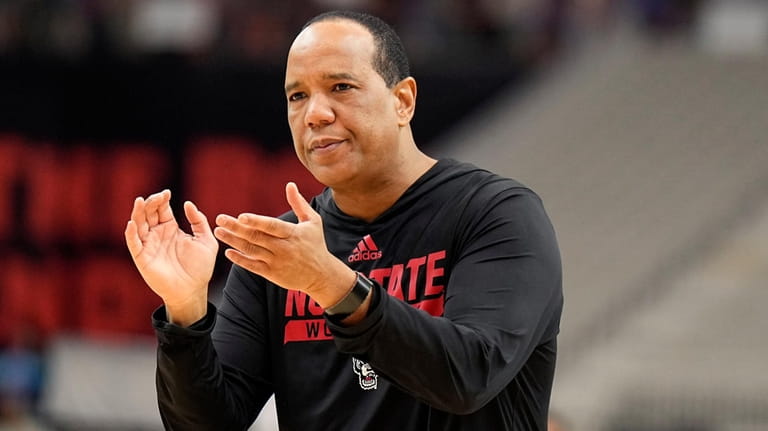 NC State head coach Kevin Keatts watches his team practice...