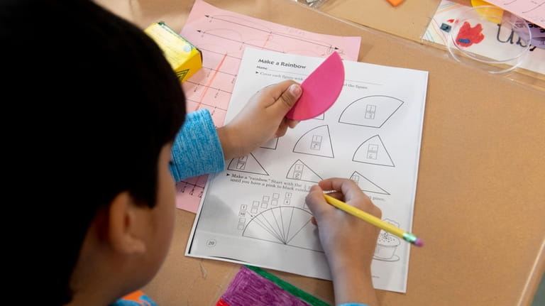 A student works on fractions Tuesday at George A. Jackson...