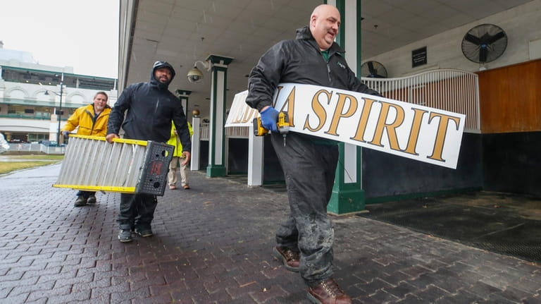 Todd Herl of the Churchill Downs sign shop carries the...