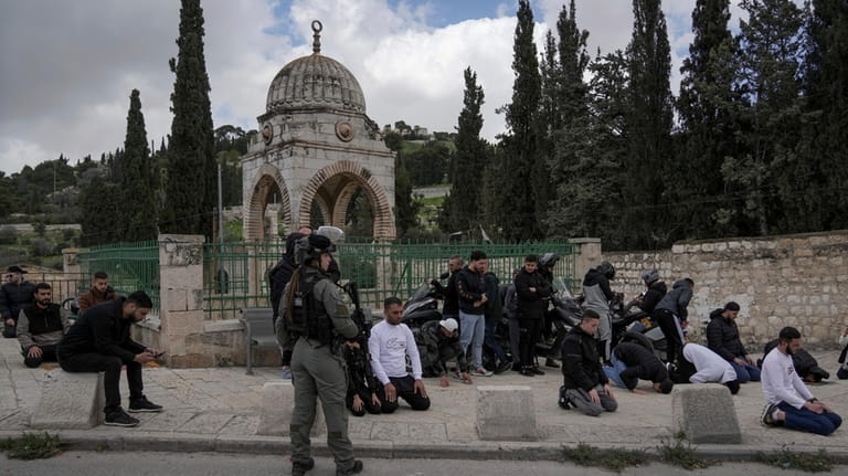 Palestinian Muslim worshipers who were prevented from entering the Al-Aqsa...