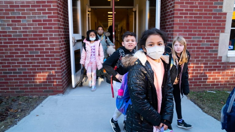 Children leave Aquebogue Elementary School in Aquebogue on Wednesday, the day...