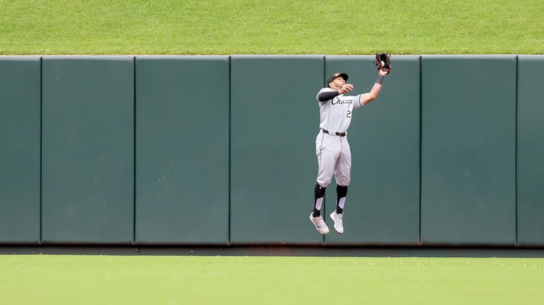 Chicago White Sox center fielder Tommy Pham catches a fly...
