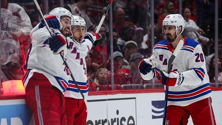 Vincent Trocheck of the New York Rangers celebrates with teammates...