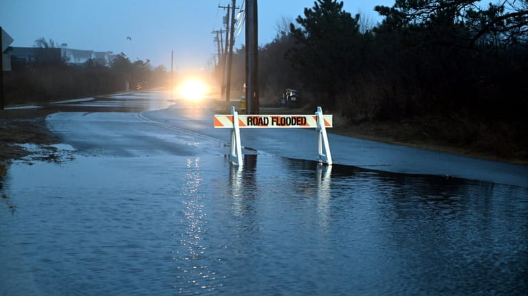 Flooding closed Dune Road, between Quogue and Hamptons Bays, after a...