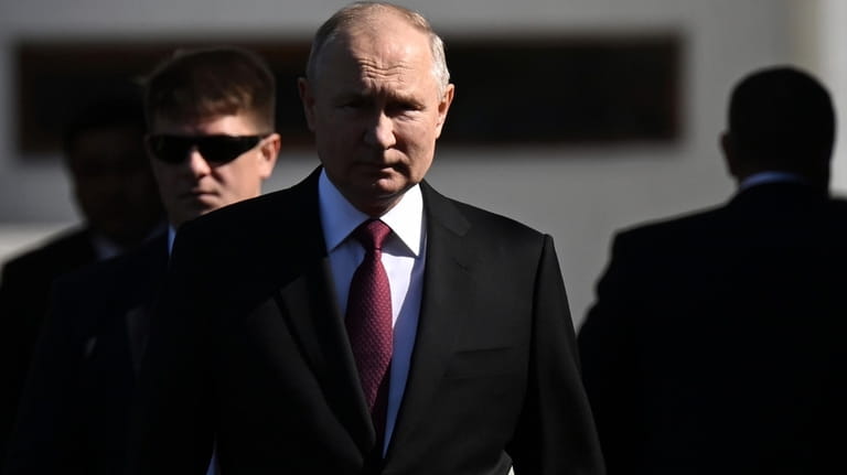 Russian President Vladimir Putin, center, walks to attend a welcome...