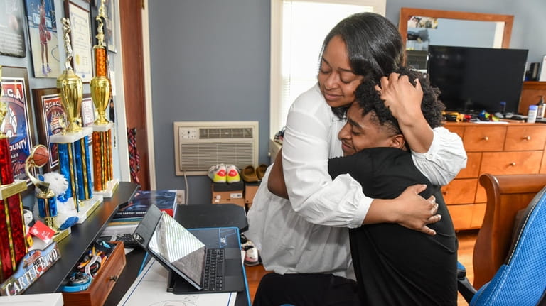 Kristin Reid hugging her son, Carter Wilson,  after reading the...