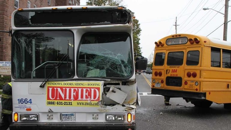 Two buses block a street Wednesday morning in Cedarhurst after...