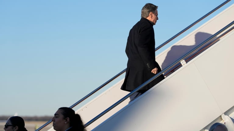 Secretary of State Antony Blinken boards a plane Sunday, Feb....