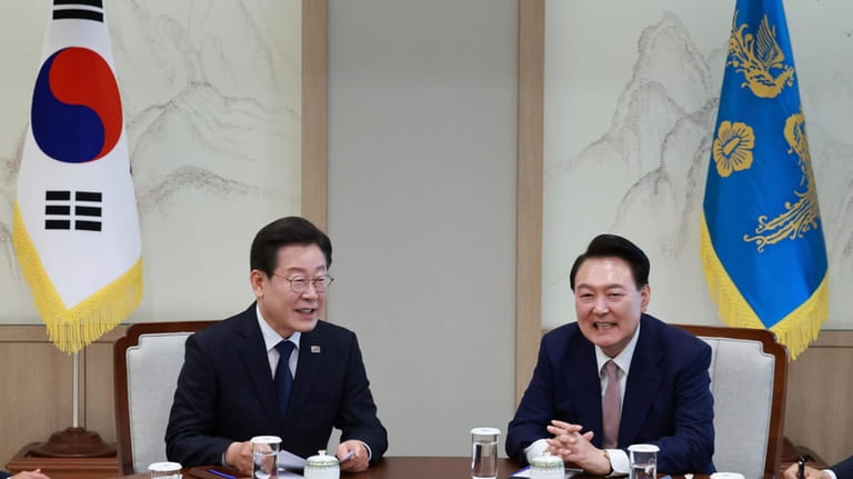 South Korean President Yoon Suk Yeol, right, talks with main...