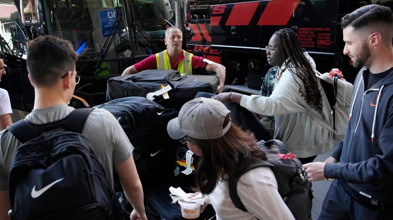 FILE -Baggage handlers and New York Liberty WNBA basketball team...