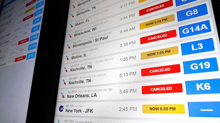 American Airlines flight information screens display flight information, including canceled...