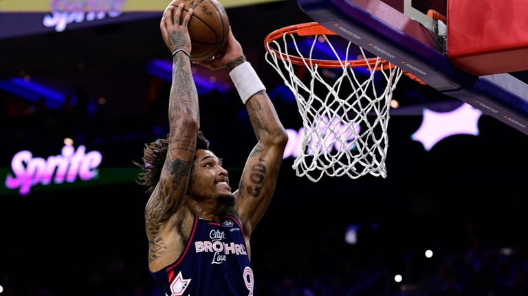 Philadelphia 76ers' Kelly Oubre Jr. goes up for a dunk...