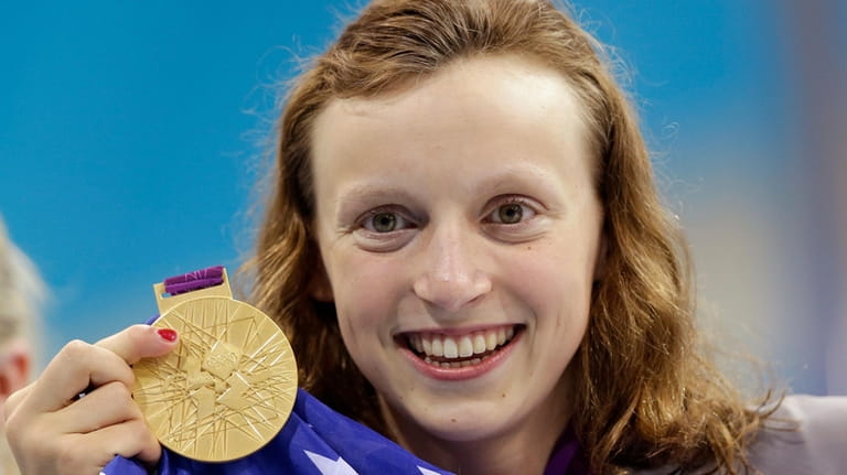 United States' Katie Ledecky holds up her gold medal after...
