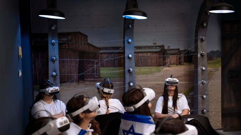 Israeli students watch a virtual tour of the concentration and...