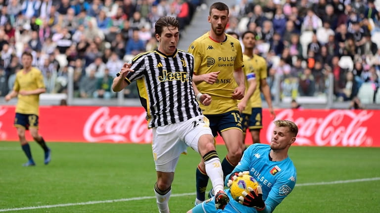 Genoa goalkeeper Josep Martinez saves on Juventus' Fabio Miretti during...