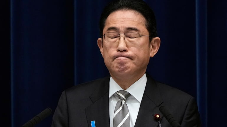 Japanese Prime Minister Fumio Kishida reacts as he speaks during...