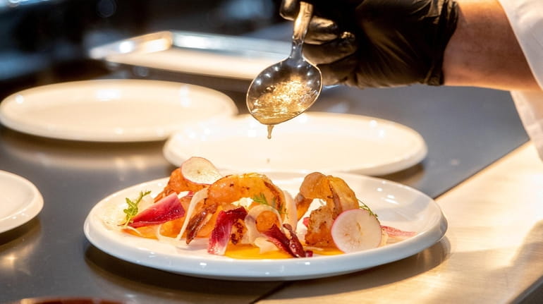 Chef Cesar Aguilar plates shrimp a la plancha at Restaurant...