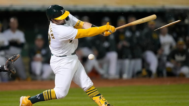 Oakland Athletics' Shea Langeliers breaks his bat while fouling off...