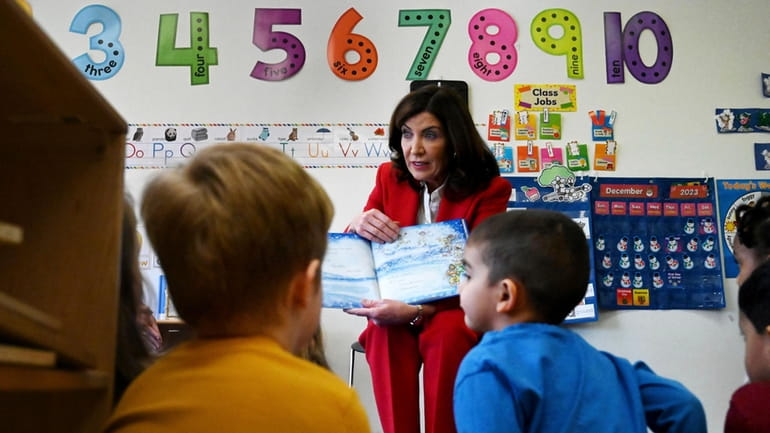 Gov. Kathy Hochul reads "Snowflakes Fall" to day care children...