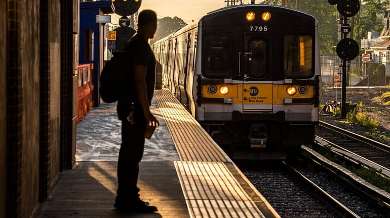 A commuter at the Mineola LIRR station in June. The report by...