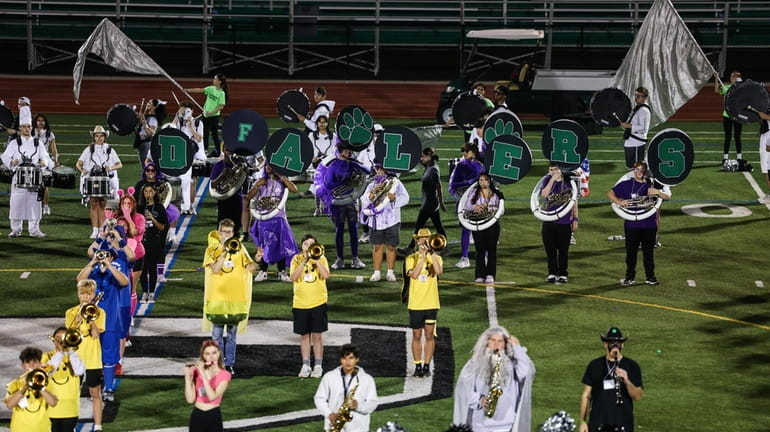 The Farmingdale High School marching band rehearses for Friday night's homecoming...