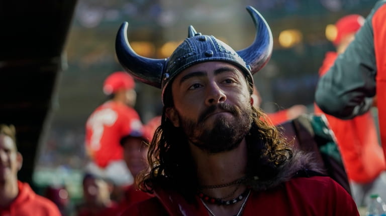 Cincinnati Reds Jonathan India wearings Viking-inspired props in the dugout...