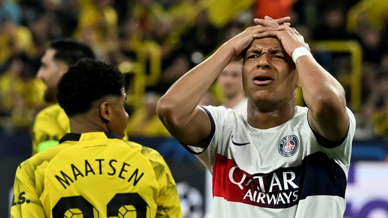 PSG's Mbappe reacts after a missed chance during the Champions...