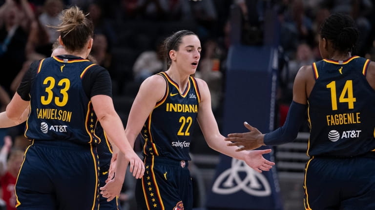 Indiana Fever's Caitlin Clark (22) is congratulated by Temi Fagbenle...