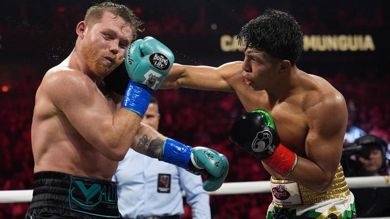 Jaime Munguia hits Canelo Alvarez in a super middleweight title...