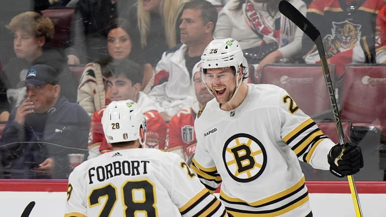 Boston Bruins defenseman Brandon Carlo (25) celebrates his goal with...