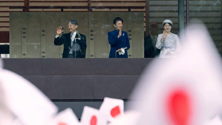 Japan's Emperor Naruhito, left, Empress Masako, center, and their daughter...