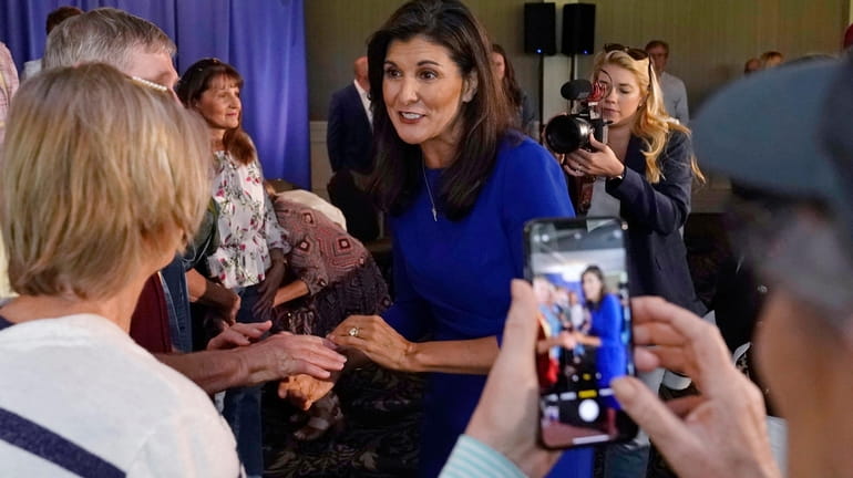 Republican presidential candidate Nikki Haley greets guests during a campaign...