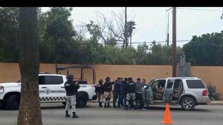 In this image made from video, Mexican security forces frisk...