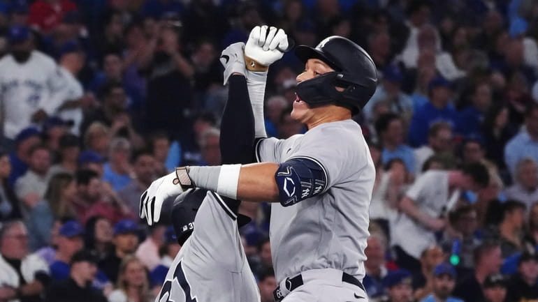 Yankees' Aaron Judge, right, celebrates his two-run home run against...