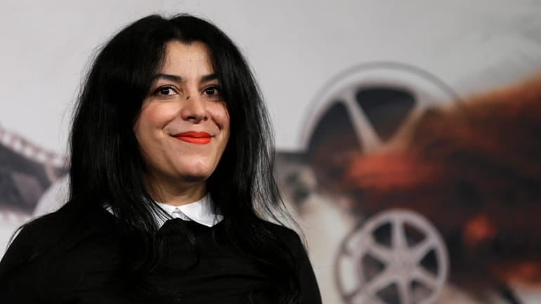 Director, illustrator and author Marjane Satrapi poses for photographers as...