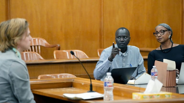 Lisa Ross, right, attorney for Bul Mabil, seated center, brother...