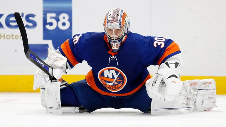 Ilya Sorokin of the New York Islanders stretches during a...