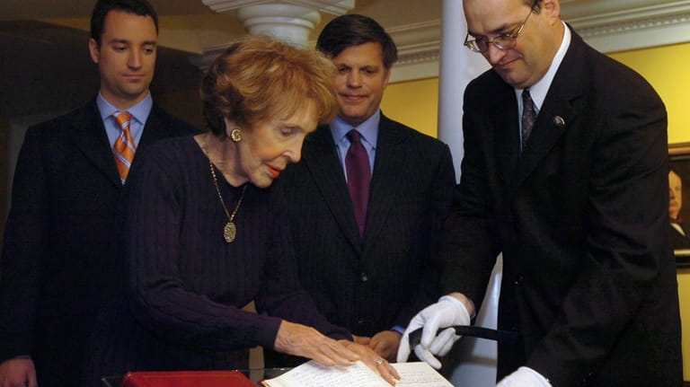 Nancy Reagan, front left, and supervisory archivist Mike Duggan, front...