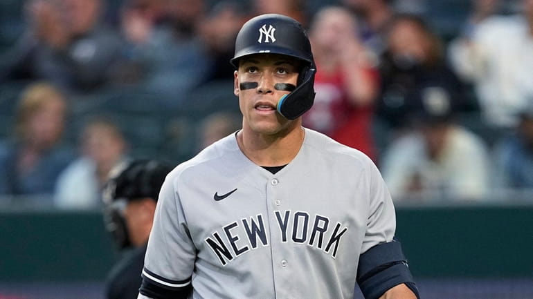 Yankees' Aaron Judge walks to the dugout after striking out...
