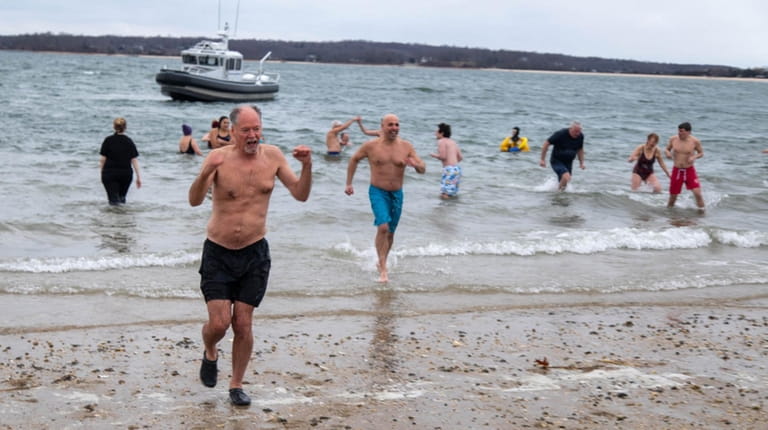 Plungers hurry out of the water during the 11th Annual...