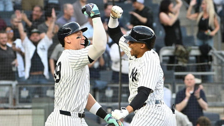 Yankees’ Aaron Judge greets Juan Soto after his two-run home...