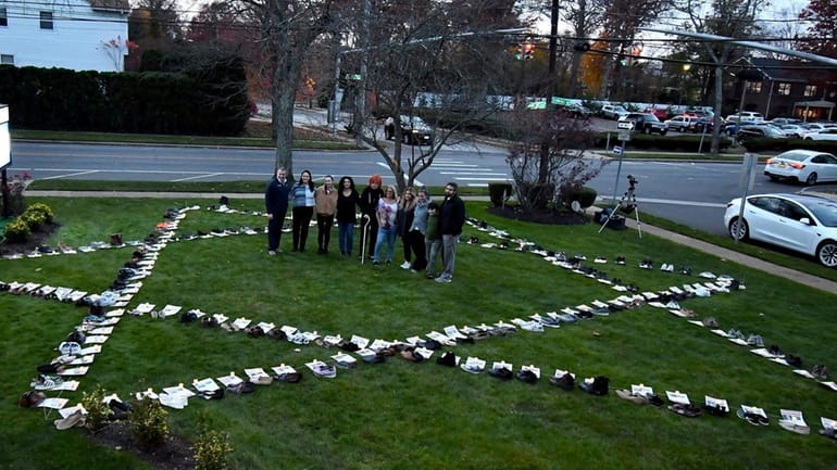 A display of shoes on the lawn of Temple Beth...